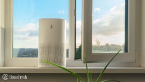 An air purifier next to an open window
